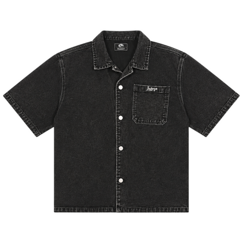 Front view of INTROVERT "Culture" heavy-weight washed black denim short sleeve button-down shirt with contrast stitching, silver hardware snap buttons, and white script branding on the chest pocket.