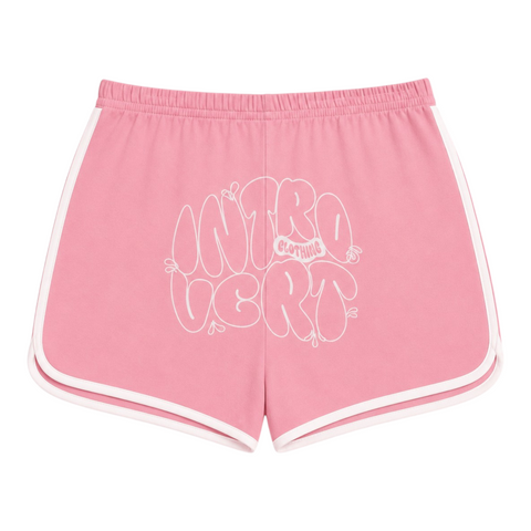 Back view of INTROVERT women's retro track shorts in pink showcasing a large white screenprinted INTROVERT CLOTHING bubble text graphic across the seat.