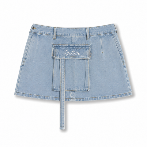 Rear side perspective of the INTROVERT light wash denim cargo skirt showcasing the structured paneling, thick belt loops, and functional utility side pockets.