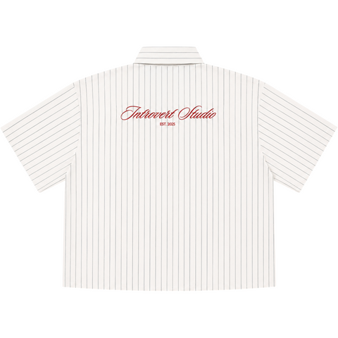 Back view of INTRV Clubhouse Pinstripe short sleeve shirt in off-white showcasing the clean vertical pinstripe fabric pattern, premium flat-hem crop finish, and structured dropped shoulder silhouette.