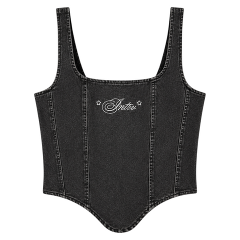 Front view of INTRV women's washed black denim corset crop top highlighting the vertical tailoring lines and central white cursive Intrv embroidery decorated with two small star icons.