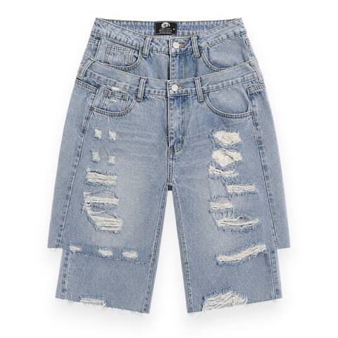 Front view of INTROVERT men's double waistband denim shorts in a light wash featuring heavy texturized deconstruction, distressed thigh panels, and a stacked dual waist layout.